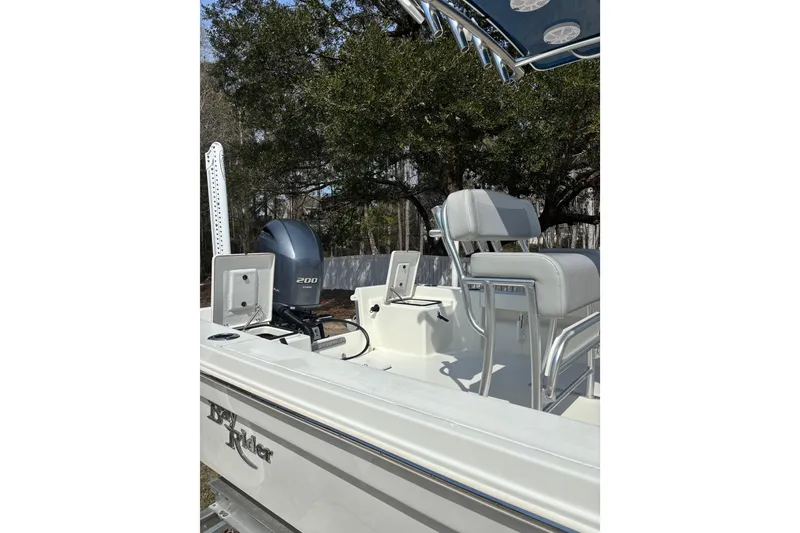 Slide: The Image of 2022 Bay Rider 239 Bay boat with Yamaha 200 engine, featuring comfortable seating and sleek design. - 16