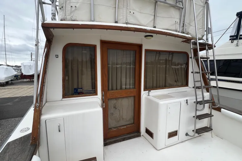 Slide: The Image of 1989 Egg Harbor 35 Sport Fisherman boat with wooden door and ladder on deck. - 10