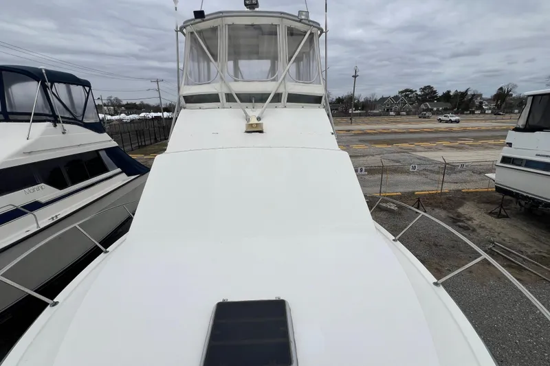 Slide: The Image of 1989 Egg Harbor 35 Sport Fisherman boat on land, surrounded by other vessels. - 13