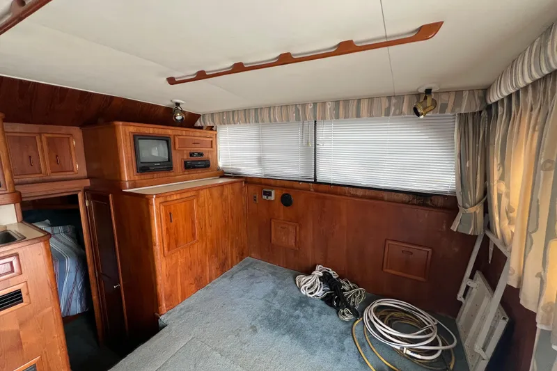 Slide: The Image of Interior of 1989 Egg Harbor 35 Sport Fisherman with wood paneling and vintage electronics. - 14