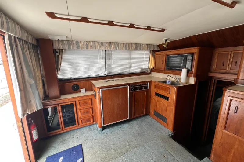 Slide: The Image of Interior of a 1989 Egg Harbor 35 Sport Fisherman with wood cabinetry and compact kitchen. - 15