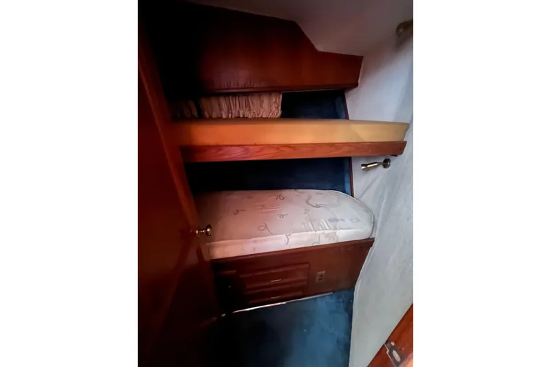 Slide: The Image of Interior cabin of 1989 Egg Harbor 35 Sport Fisherman with bunk beds and wooden accents. - 20