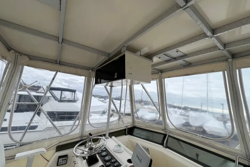 Slide: The Image of Interior view of 1989 Egg Harbor 35 Sport Fisherman boat helm with marina background. - 29