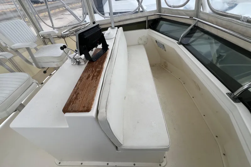 Slide: The Image of 1989 Egg Harbor 35 Sport Fisherman cockpit with seating and control panel. - 30