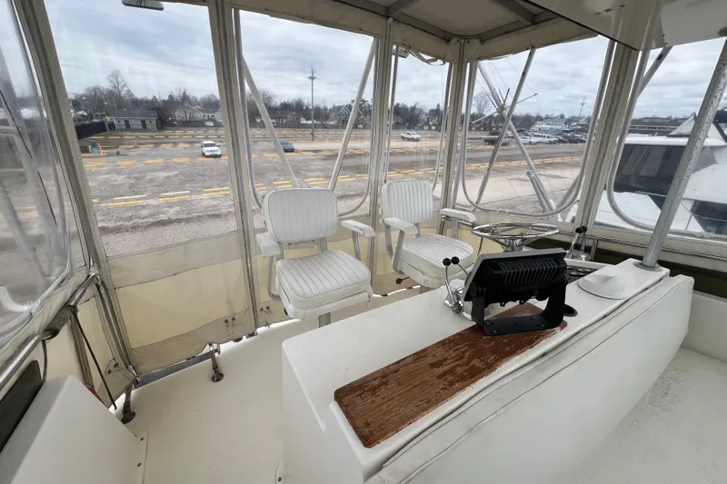 Slide: The Image of Interior view of 1989 Egg Harbor 35 Sport Fisherman boat cockpit with seating and controls. - 31