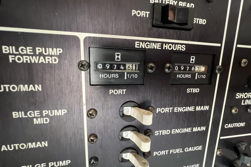 Slide: The Image of Control panel of a 1989 Egg Harbor 35 Sport Fisherman showing engine hours and bilge pump switches. - 33