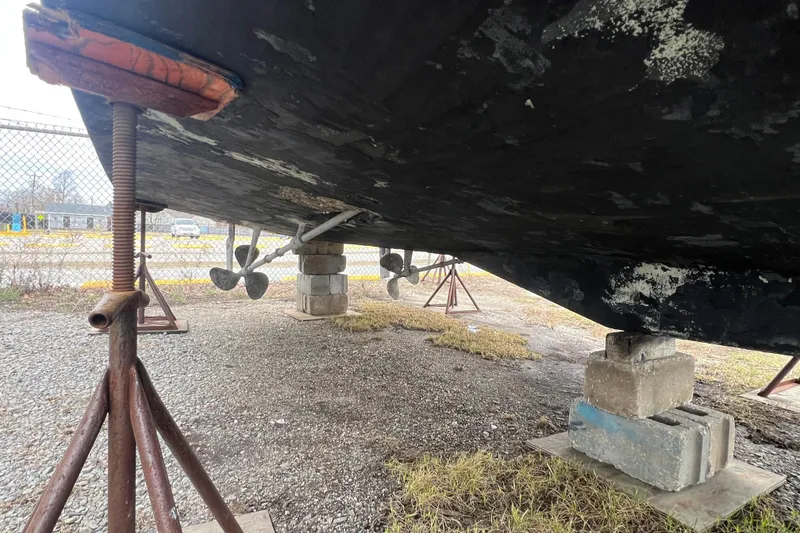 Slide: The Image of Underneath view of a 1989 Egg Harbor 35 Sport Fisherman boat on supports. - 38