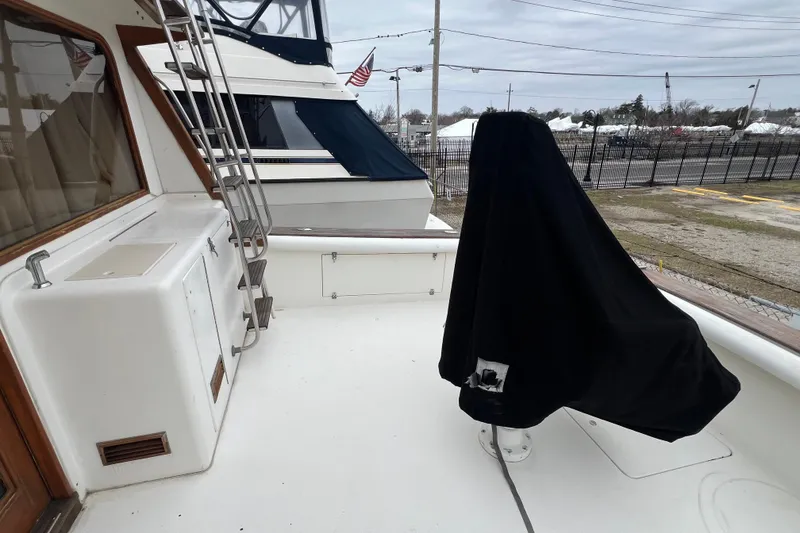 Slide: The Image of 1989 Egg Harbor 35 Sport Fisherman deck with covered equipment and ladder. - 9