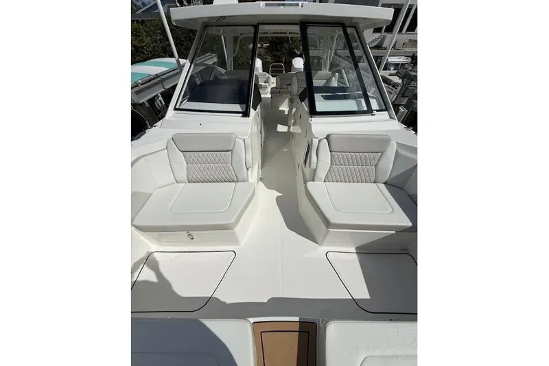 Slide: The Image of 2026 World Cat 400 DC-X Island boat with spacious seating and modern design. - 11