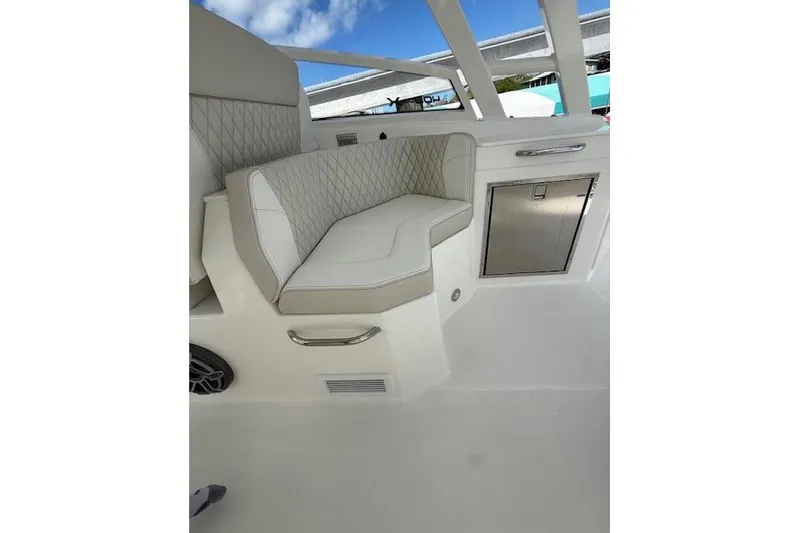 Slide: The Image of Luxurious seating on 2026 World Cat 400 DC-X Island boat, featuring elegant design and storage. - 14