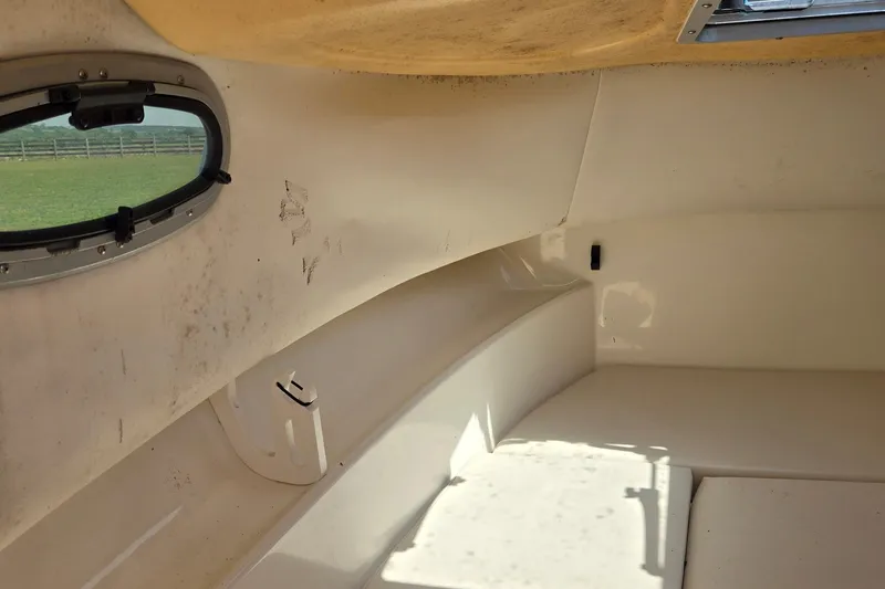 Slide: The Image of 2006 Boston Whaler 205 Conquest boat on trailer under a partly cloudy sky. - 11