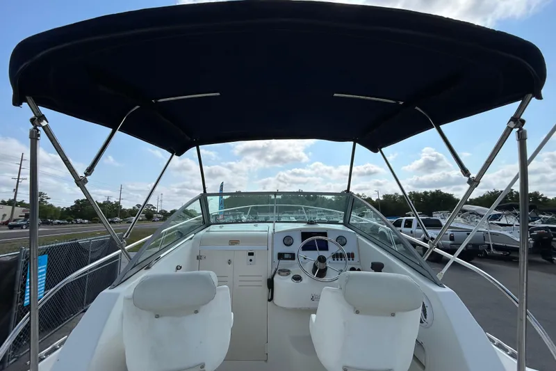 Slide: The Image of 2006 Boston Whaler 205 Conquest boat cockpit with canopy and steering wheel. - 18