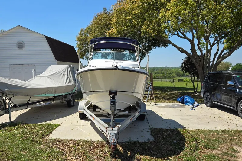 Slide: The Image of 2006 Boston Whaler 205 Conquest boat on trailer with Mercury outboard motor. - 2