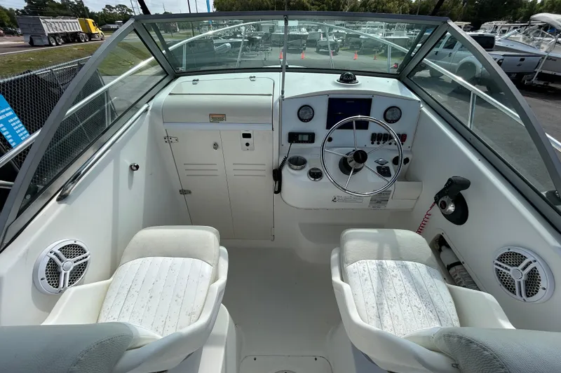Slide: The Image of 2006 Boston Whaler 205 Conquest boat cockpit with steering wheel and seating. - 20