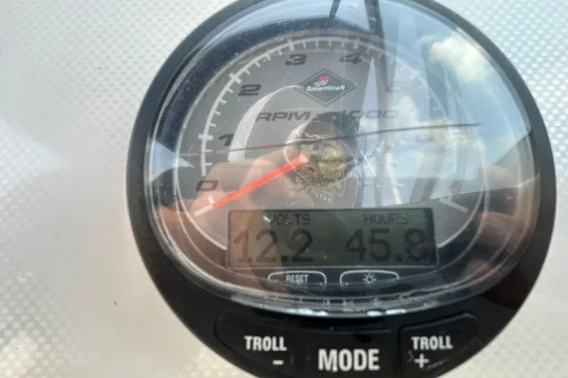Slide: The Image of Close-up of a 2006 Boston Whaler 205 Conquest boat gauge displaying volts and hours. - 22