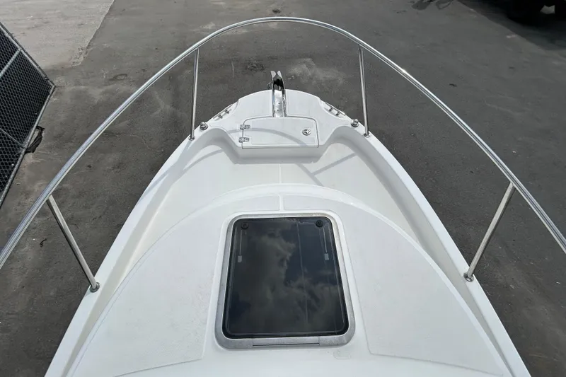Slide: The Image of 2006 Boston Whaler 205 Conquest boat deck with railing and hatch. - 24