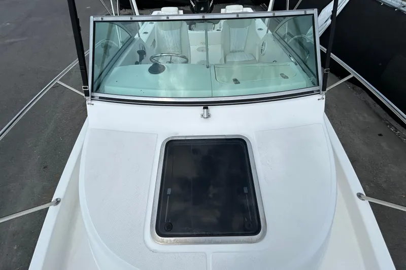 Slide: The Image of 2006 Boston Whaler 205 Conquest boat with windshield and deck hatch. - 28