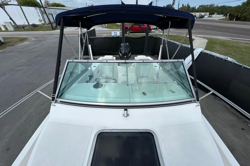 Slide: The Image of 2006 Boston Whaler 205 Conquest boat with canopy and windshield. - 31