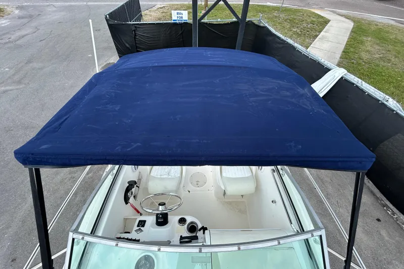Slide: The Image of 2006 Boston Whaler 205 Conquest with blue canopy, top view. - 34