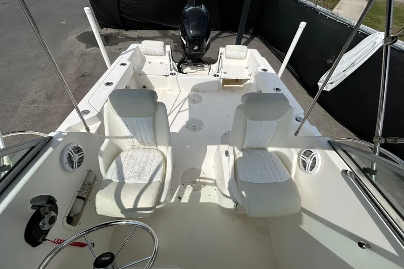 Slide: The Image of Interior of a 2006 Boston Whaler 205 Conquest boat with white seating. - 36