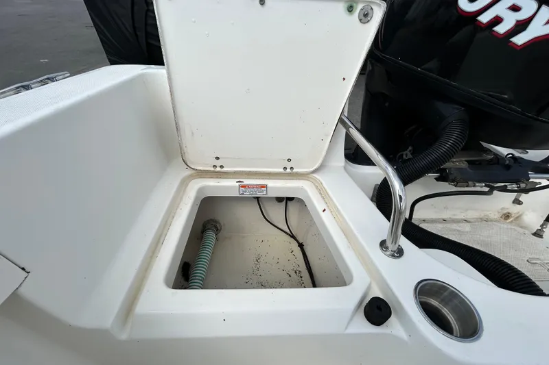 Slide: The Image of Open storage compartment on a 2006 Boston Whaler 205 Conquest boat. - 42