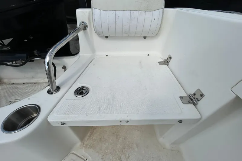 Slide: The Image of 2006 Boston Whaler 205 Conquest boat seat with cup holder and stainless steel railing. - 44