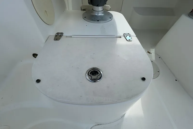 Slide: The Image of 2006 Boston Whaler 205 Conquest boat hatch with metal hinges and latch. - 47