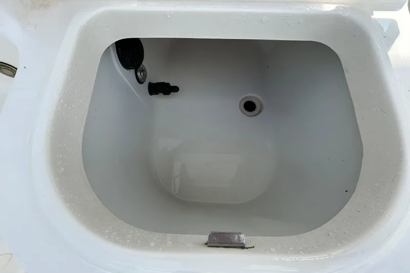 Slide: The Image of Livewell compartment on a 2006 Boston Whaler 205 Conquest boat, showing interior details. - 49
