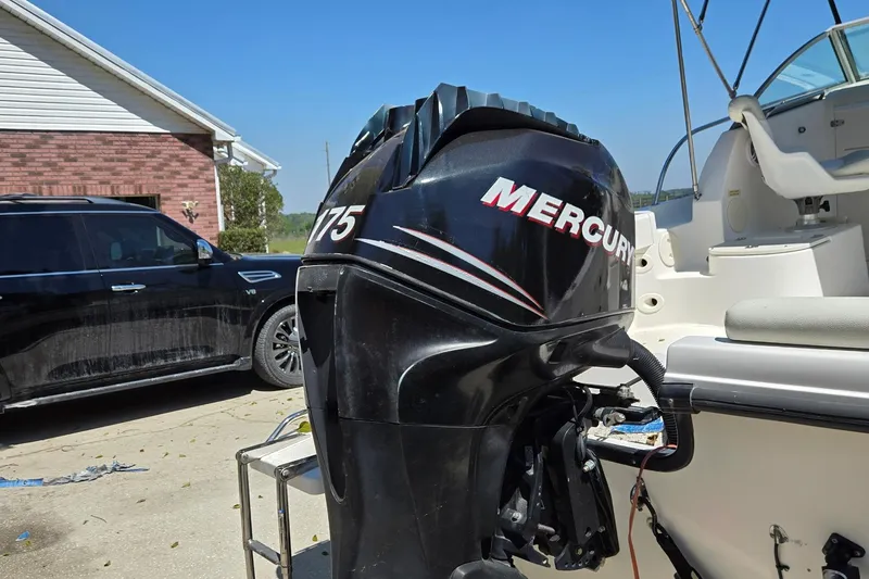 Slide: The Image of 2006 Boston Whaler 205 Conquest boat with 175 horsepower engine, parked outdoors. - 5