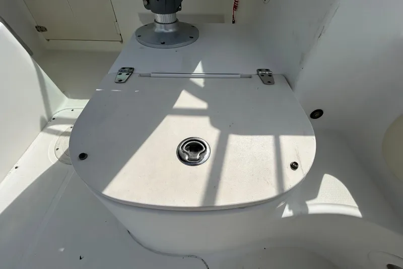 Slide: The Image of 2006 Boston Whaler 205 Conquest boat interior with storage compartment and latch. - 50