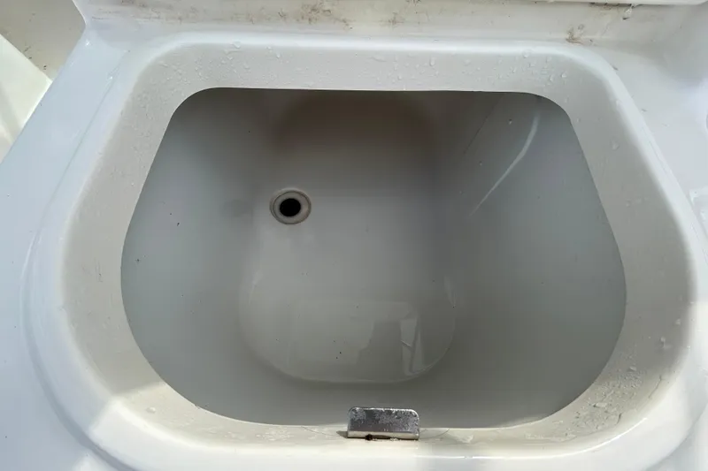 Slide: The Image of Livewell compartment on a 2006 Boston Whaler 205 Conquest boat, showing interior details. - 52