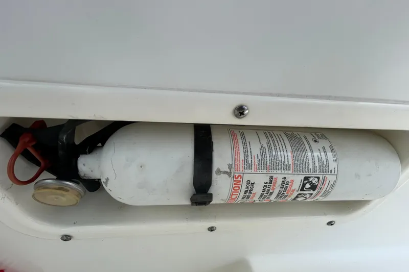 Slide: The Image of Fire extinguisher mounted on a 2006 Boston Whaler 205 Conquest boat. - 53