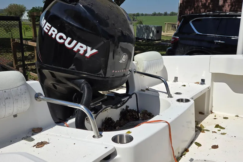 Slide: The Image of Rear view of a 2006 Boston Whaler 205 Conquest boat with motor and ladder. - 6