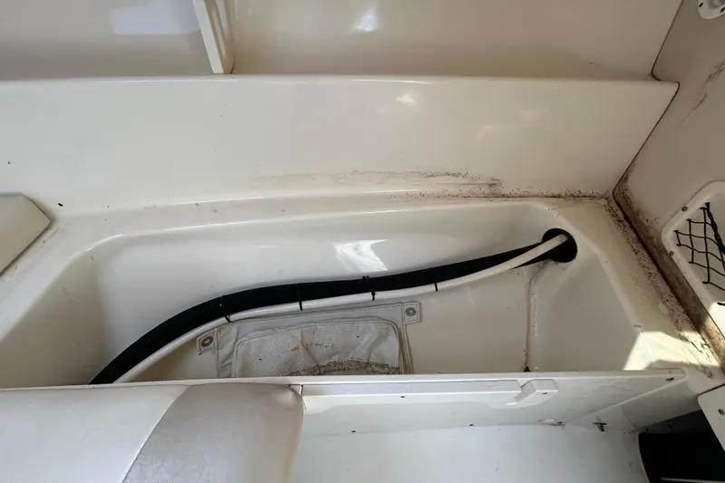 Slide: The Image of Interior of a 2006 Boston Whaler 205 Conquest boat, showing storage area. - 63