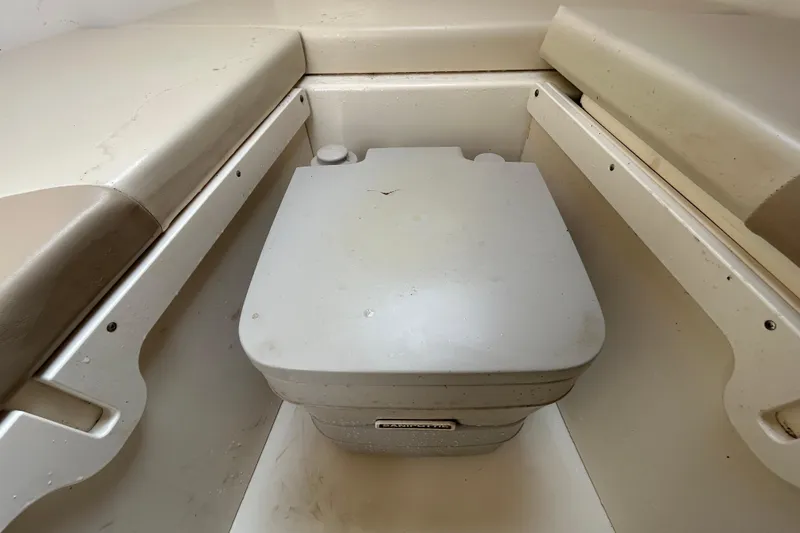 Slide: The Image of Interior of a 2006 Boston Whaler 205 Conquest with portable toilet. - 66