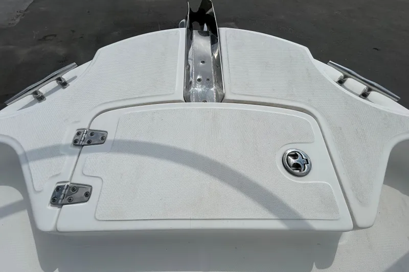 Slide: The Image of 2006 Boston Whaler 205 Conquest boat deck with storage hatch and stainless steel fittings. - 71