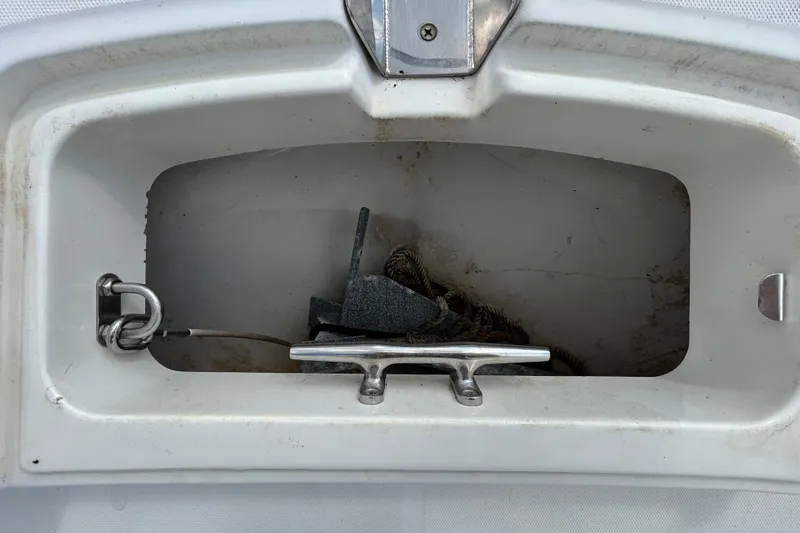 Slide: The Image of Anchor compartment of 2006 Boston Whaler 205 Conquest boat with rope and cleat. - 73