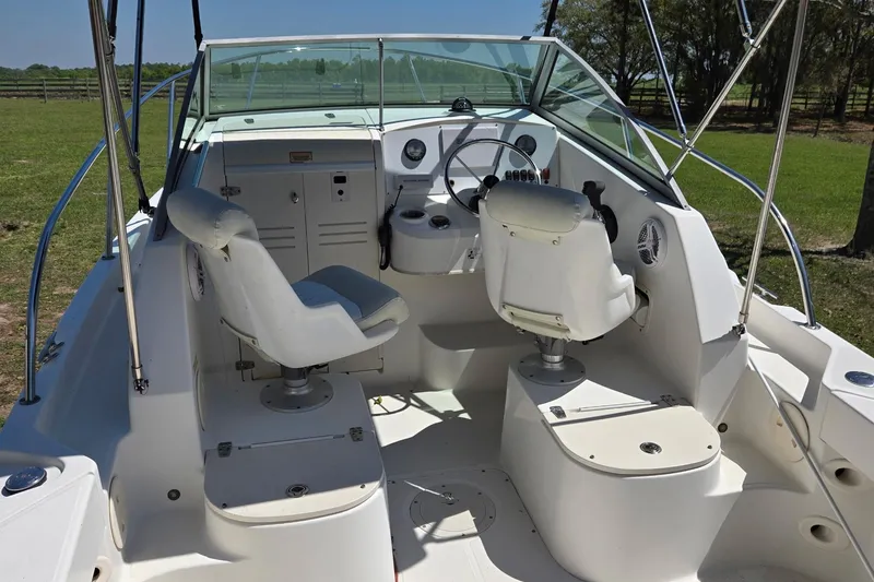 Slide: The Image of 2006 Boston Whaler 205 Conquest with Mercury outboard motor in a parking lot. - 8