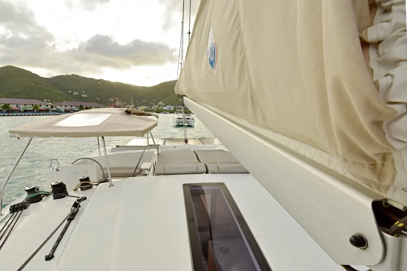 Slide: The Image of 2024 Fountaine Pajot Astrea 42 catamaran sailing in a scenic coastal harbor. - 10