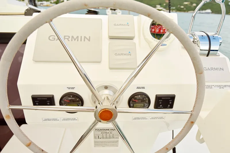 Slide: The Image of Steering wheel and controls of 2024 Fountaine Pajot Astrea 42 catamaran with Garmin navigation. - 11