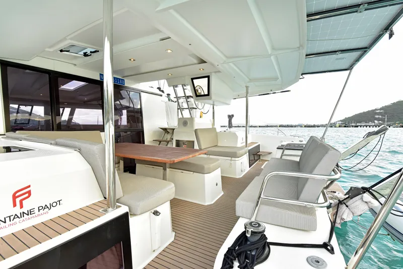 Slide: The Image of 2024 Fountaine Pajot Astrea 42 catamaran deck with seating and ocean view. - 13