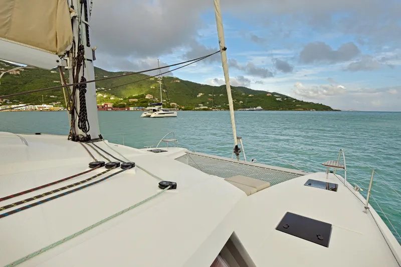 Slide: The Image of 2024 Fountaine Pajot Astrea 42 catamaran sailing in scenic coastal waters. - 14