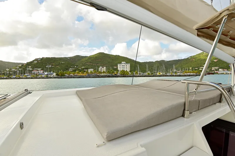 Slide: The Image of 2024 Fountaine Pajot Astrea 42 yacht with scenic marina view and lush green hills. - 16