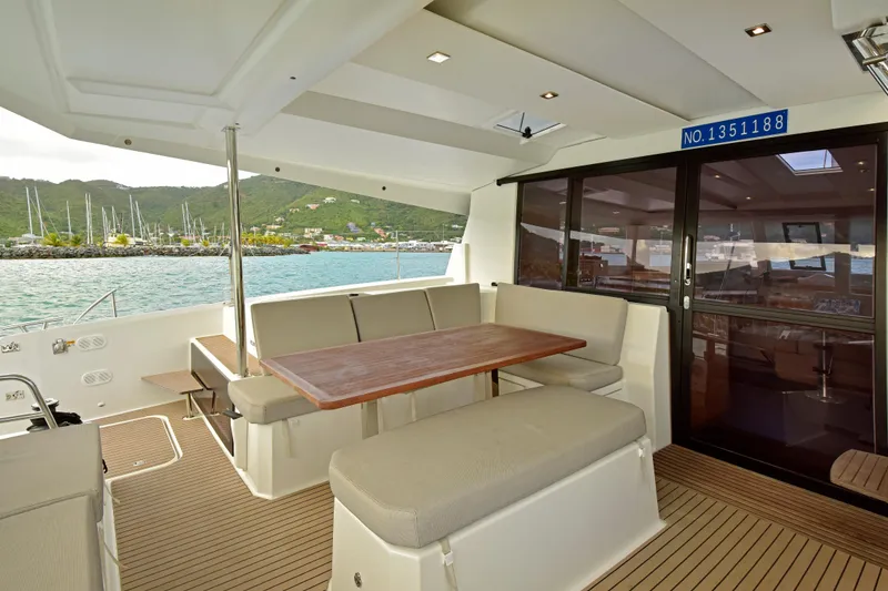 Slide: The Image of 2024 Fountaine Pajot Astrea 42 yacht interior with spacious seating and scenic marina view. - 17