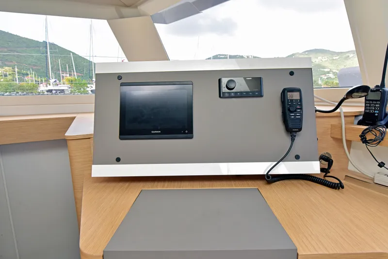 Slide: The Image of Navigation console of 2024 Fountaine Pajot Astrea 42 catamaran with Garmin display and radio. - 21