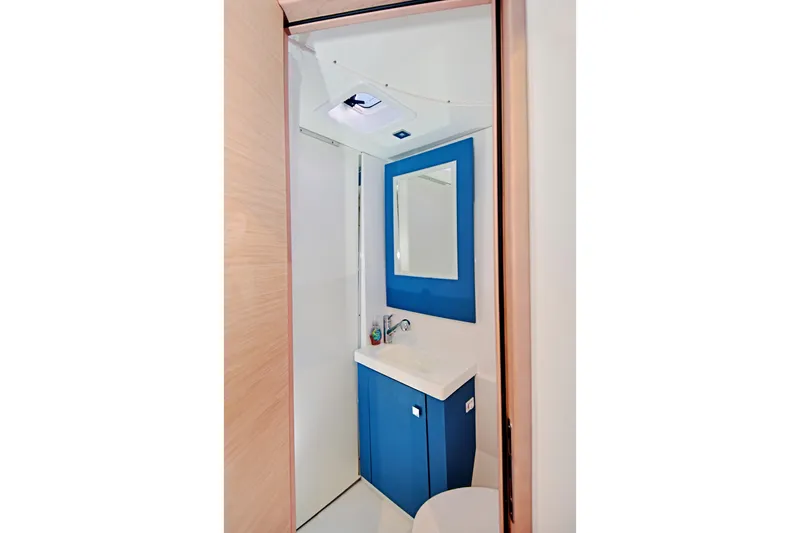 Slide: The Image of Modern bathroom interior of 2024 Fountaine Pajot Astrea 42 yacht, featuring blue cabinetry. - 33