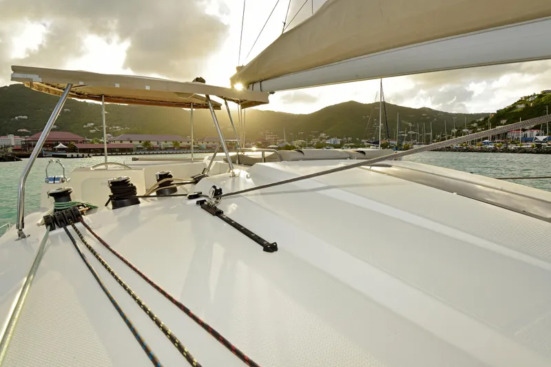 Slide: The Image of 2024 Fountaine Pajot Astrea 42 catamaran deck with scenic coastal view at sunset. - 12