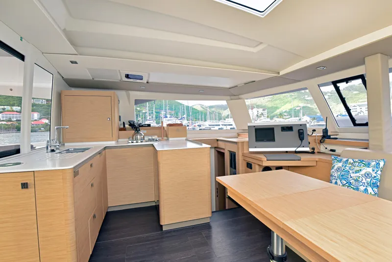 Slide: The Image of Interior of 2024 Fountaine Pajot Astrea 42 catamaran with modern kitchen and navigation area. - 22