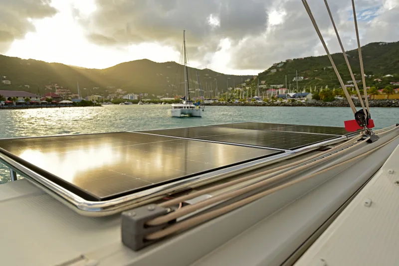 Slide: The Image of 2024 Fountaine Pajot Astrea 42 catamaran with solar panels, docked at sunset. - 9