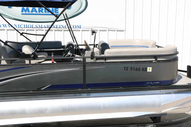 Slide: The Image of 2023 Qwest E820 XRE CR L pontoon boat with sleek design and comfortable seating. - 16